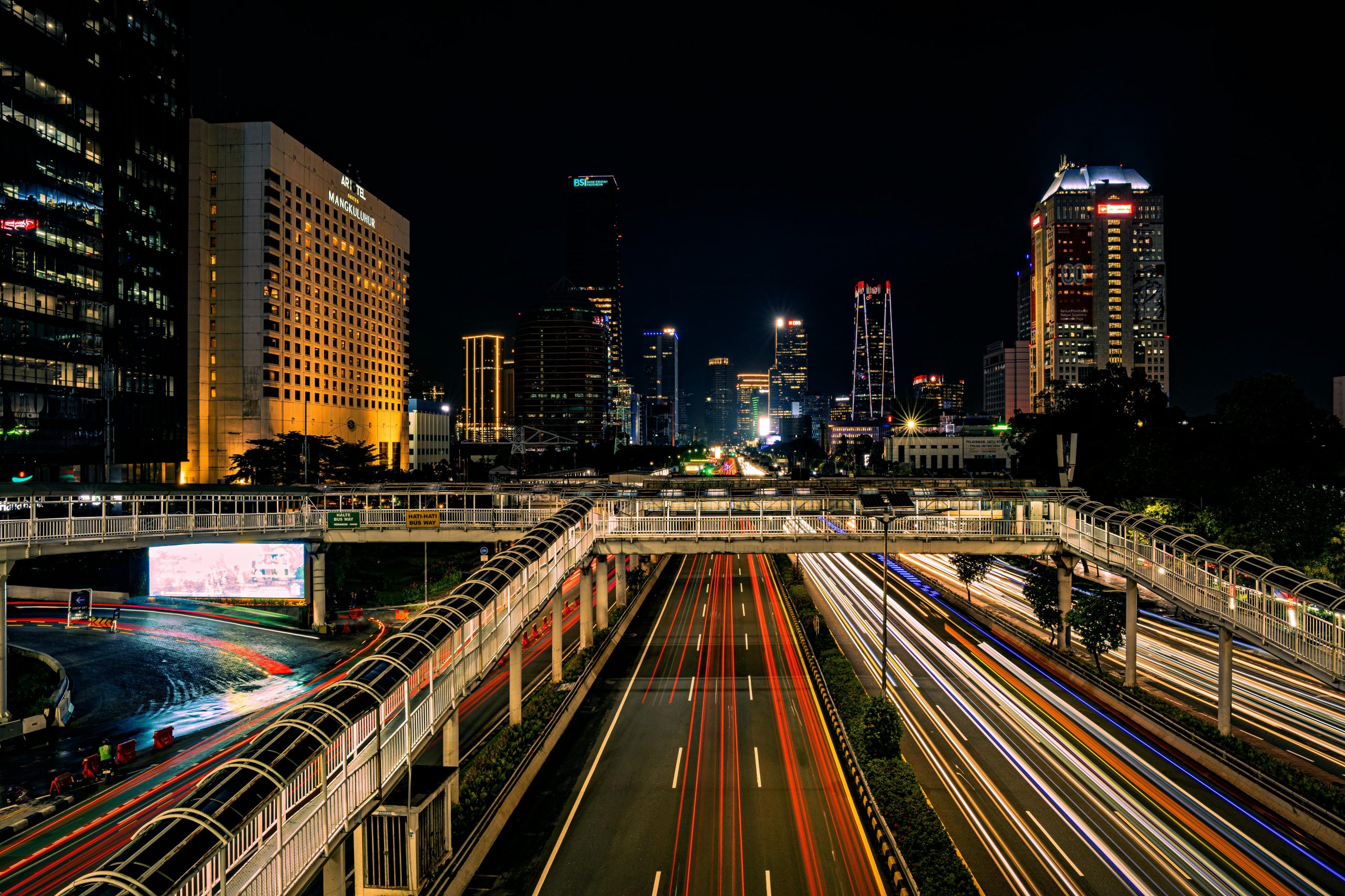 Long exposure night shot capturing Jakarta's vibrant skyline and bustling traffic.