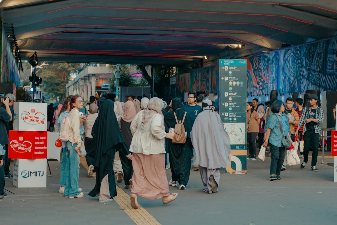 People walking through an urban underpass in Indonesia, representing everyday life and resilience amid unequal opportunities.